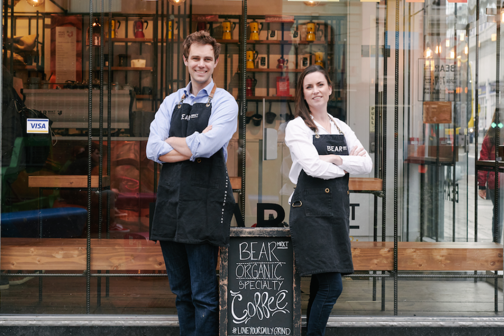 Man and woman standing with arms folded outside a coffee roastery in Dublin.