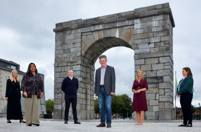 Group of people standing under an arch in Dublin.
