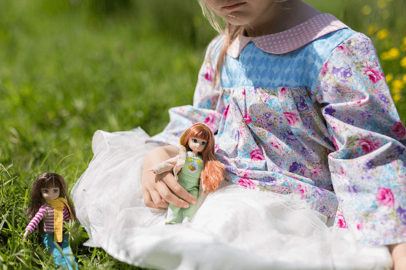 girl playing with dolls.