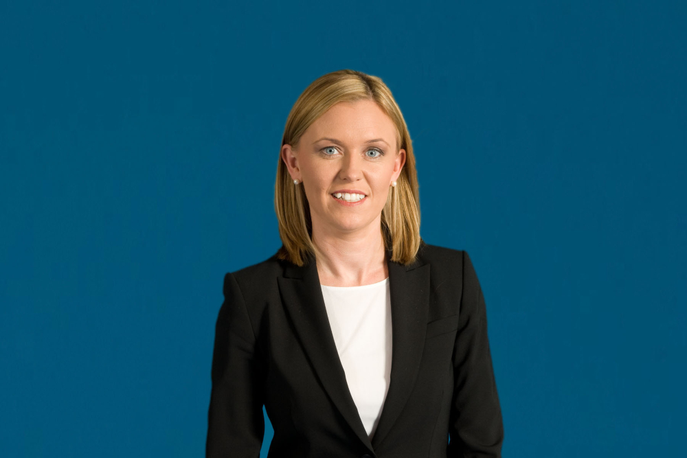 Blonde-haired woman in business suit.