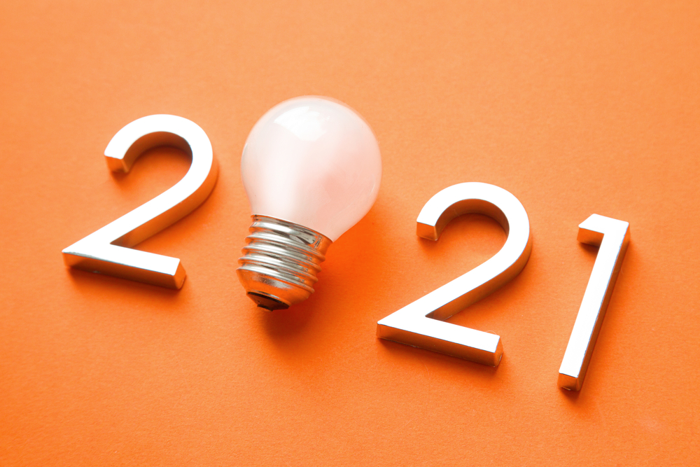 2021 with a light bulb on a coral background.