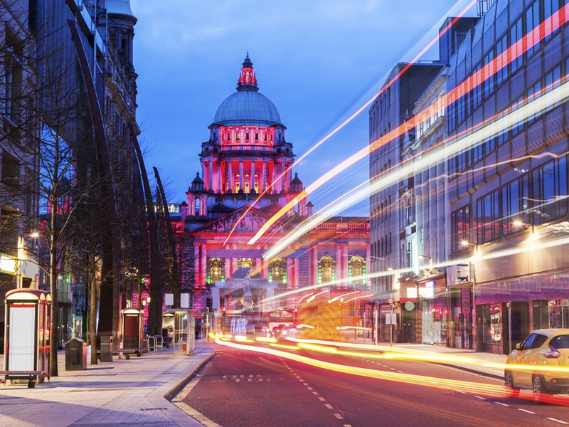 Lights flitting down a street in Belfast.