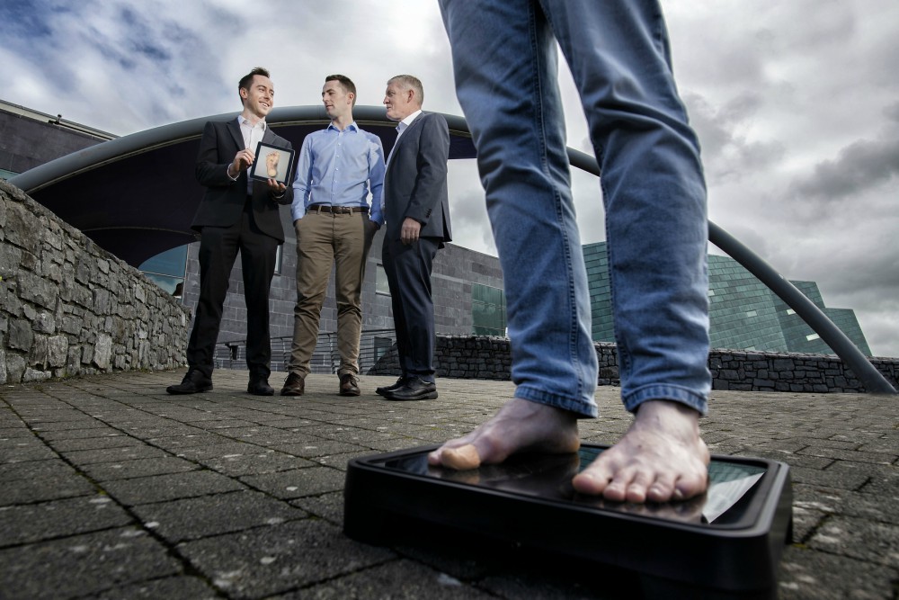 Man on scales in front of three men.