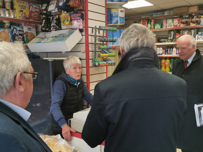 Woman in shop talking to judges.