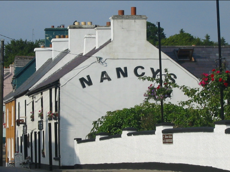 Nancy's bar in Ardara, Donegal, beside a white-washed bridge.