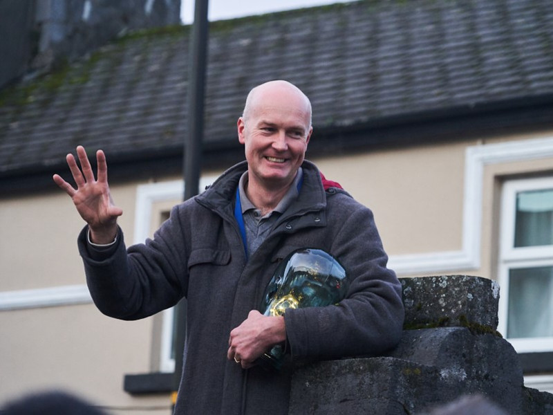 Man gesturing with hand in air.