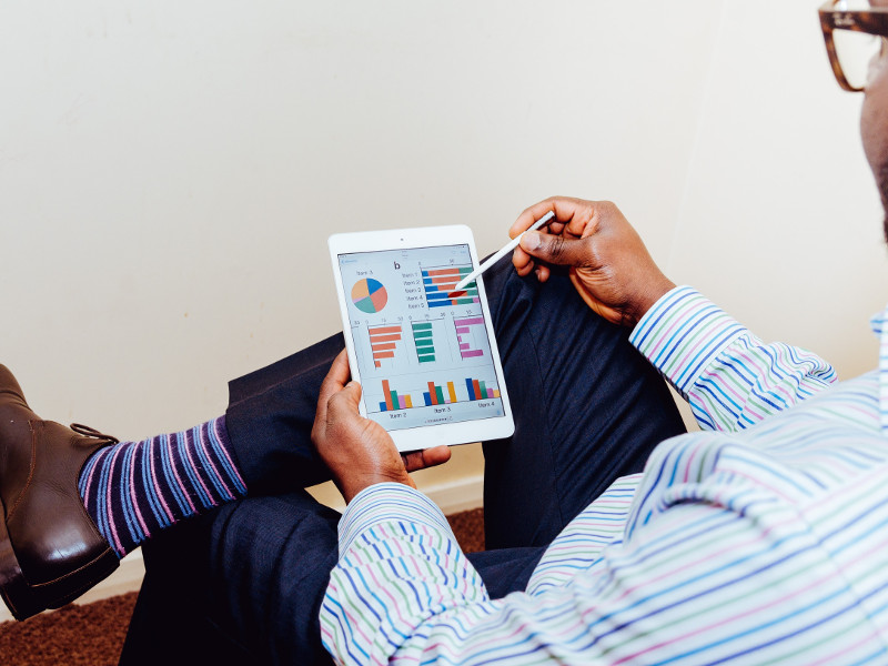 Man doing calculations on a tablet computer.