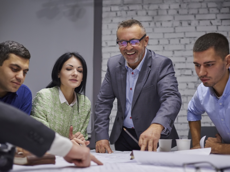 Management team at work over a table.