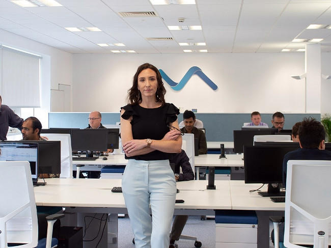 Dark-haired woman in an office.