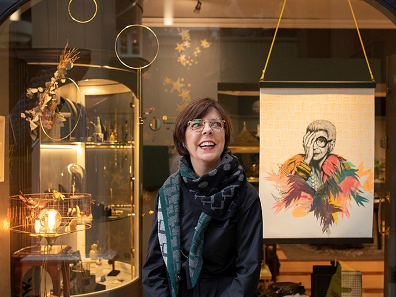 Smiling woman outside a jewellery shop.