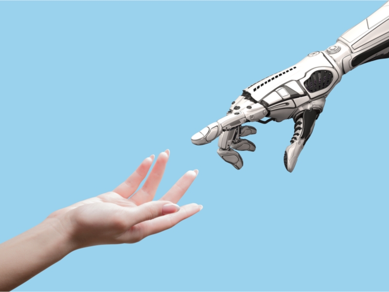 Human and and robot hand almost touching.