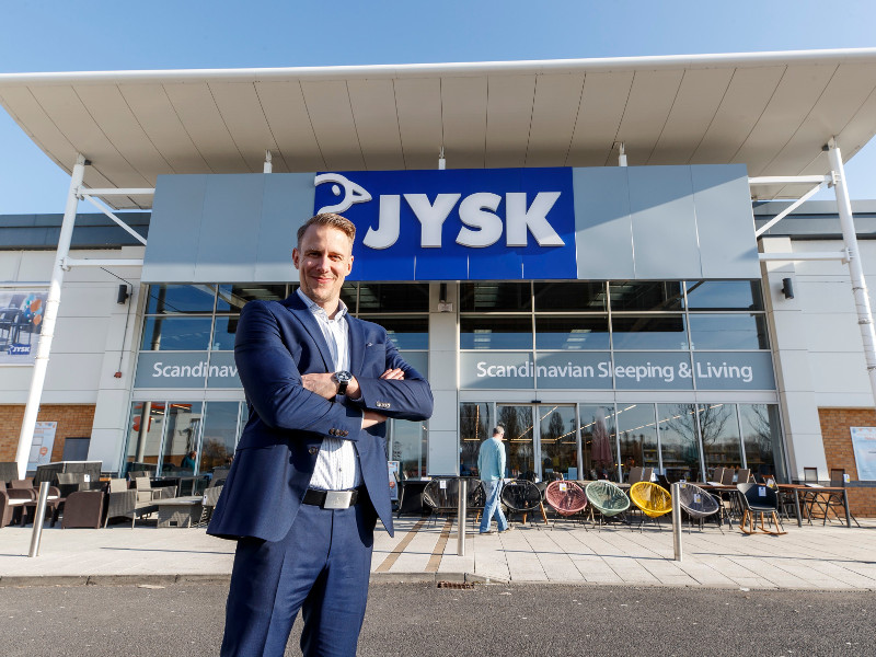 Man in blue suit standing outside JYSK store in Naas.