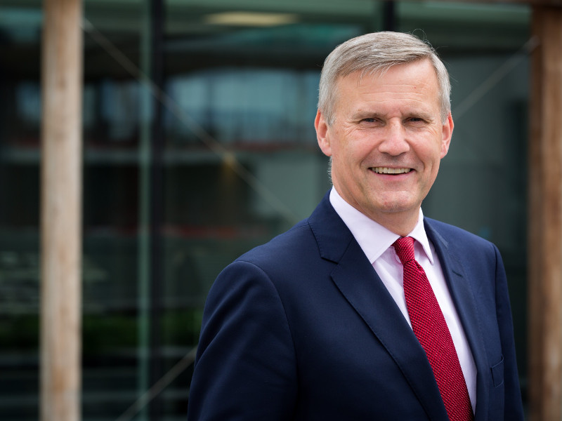 Man in navy suit and red tie.