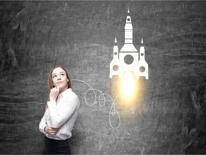 Woman thinking beside a rocket launching.