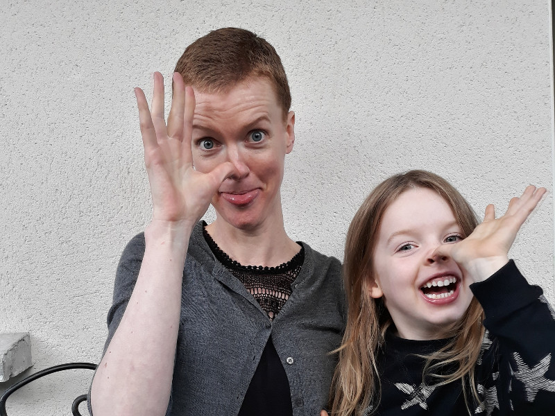 Woman and her daughter pulling faces.