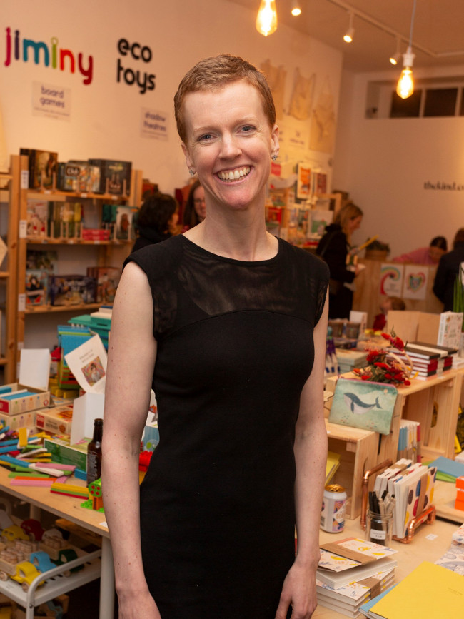 Short-haired woman in a black dress.