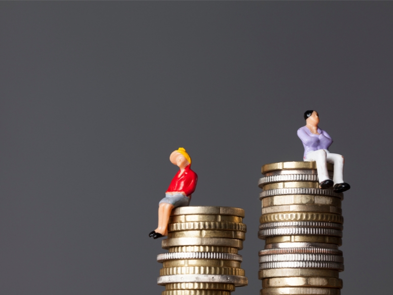 Man sitting on a higher stack of coins than a woman.