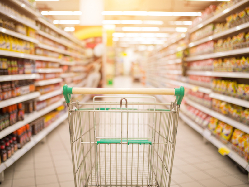 Empty shopping trolley in an empty aisle.