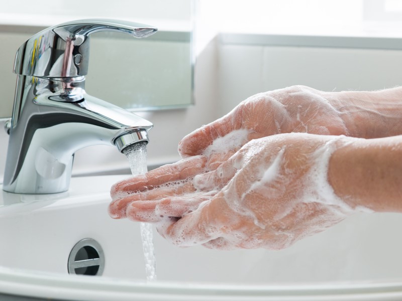 Person washing their hands in soap.