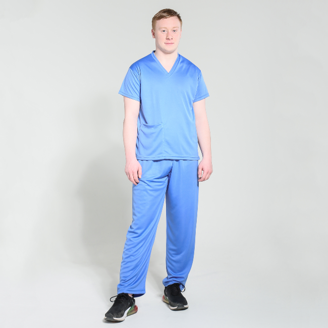 Young man wearing blue hospital scrubs.