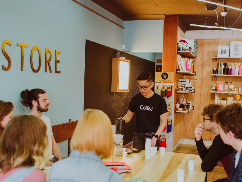 Man serving coffee in a coffee shop.