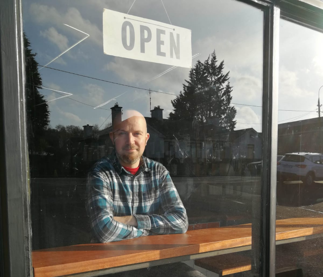 Man sitting in shop window.