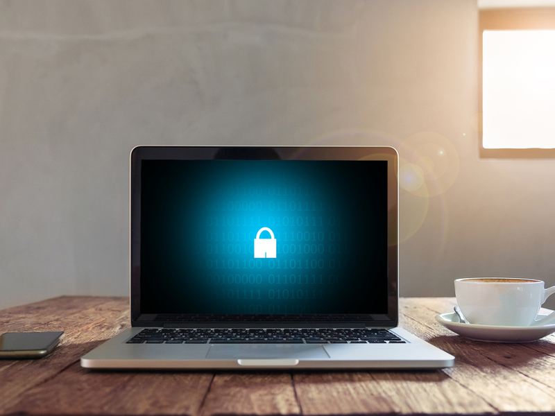 Computer on a home desk with a lock on the screen.