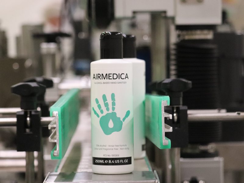 Airmedica hand sanitiser bottle on assembly line.