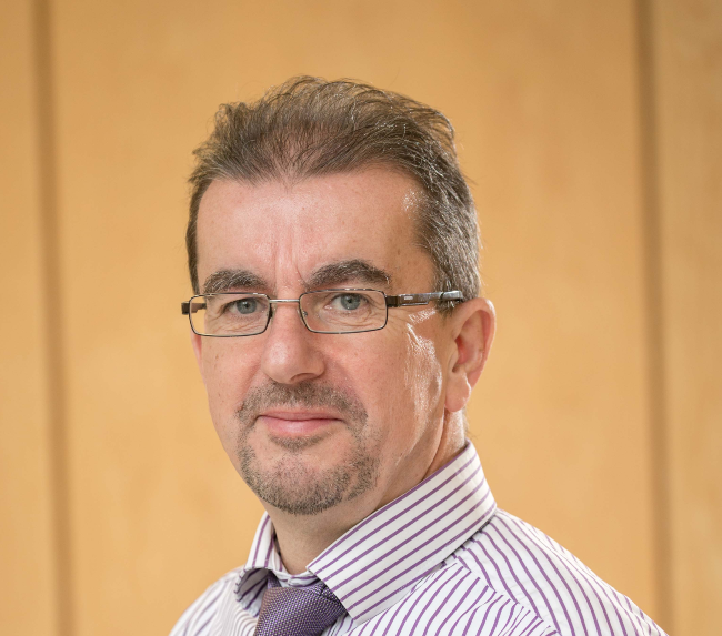 Man with glasses, purple tie.