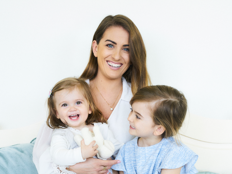 Dark-haired woman with her two children.