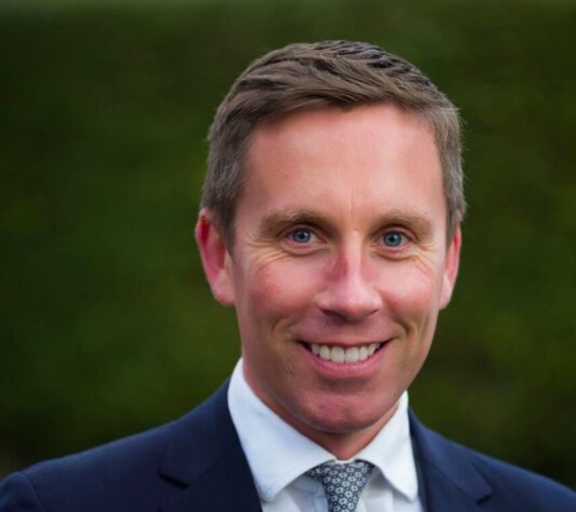 Smiling man with blue suit.