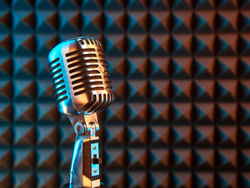 retro microphone against soundproofed wall.