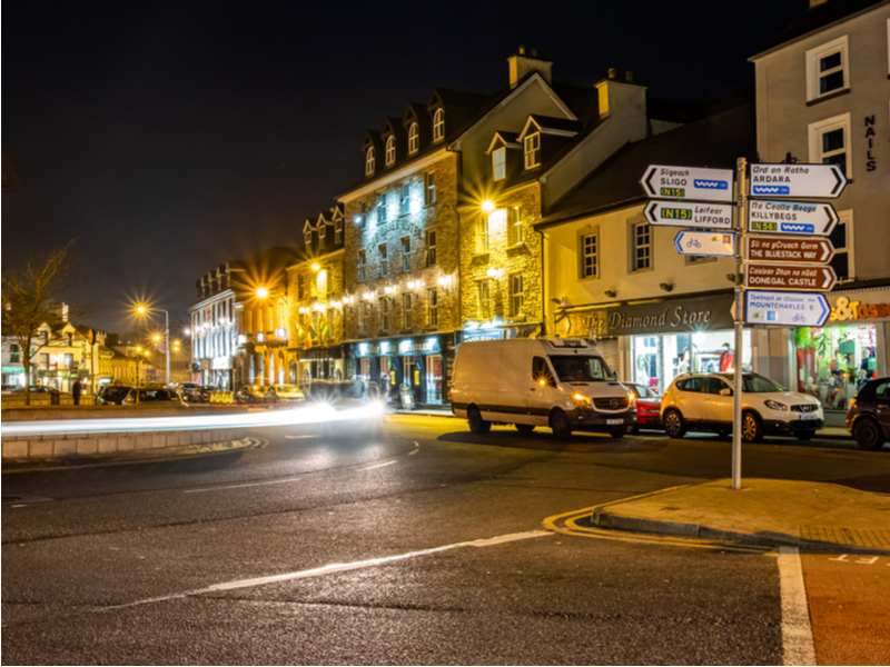 Donegal town at night with lights blurred.