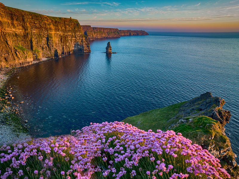 Cliffs of Moher over a blue sea.
