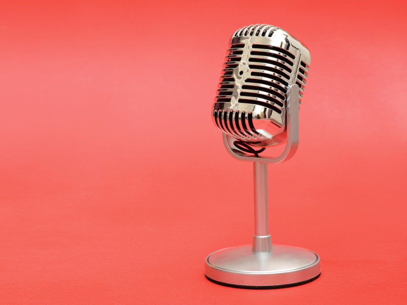 vintage microphone against a pink background.