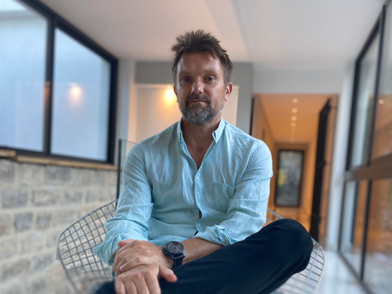 Man in blue shirt with greying beard.