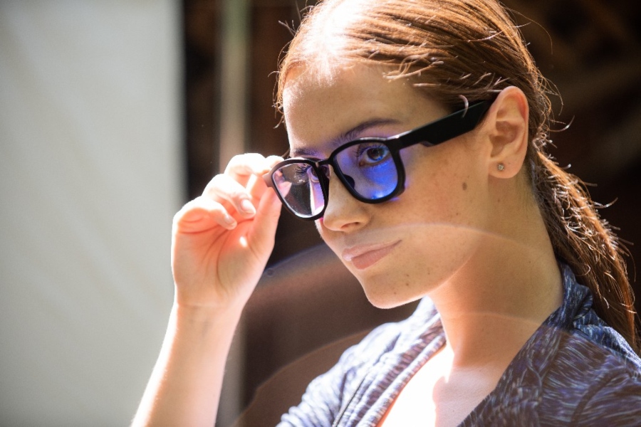 woman wearing cloloured glasses.