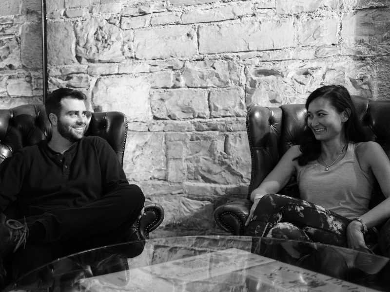 Young man and woman sitting at a table.