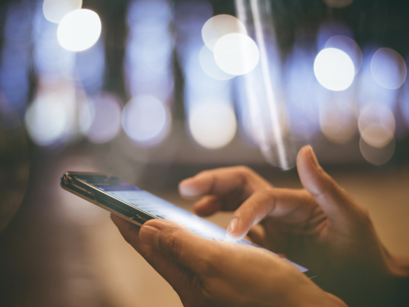 Woman using a smartphone at night.