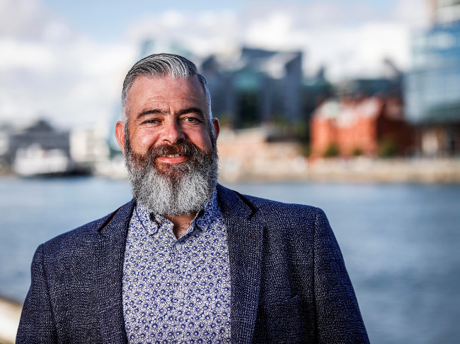 Smiling man with beard.