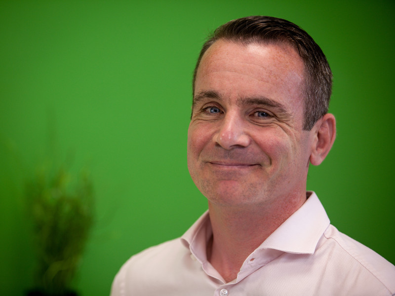 Dark-haired man in white shirt.