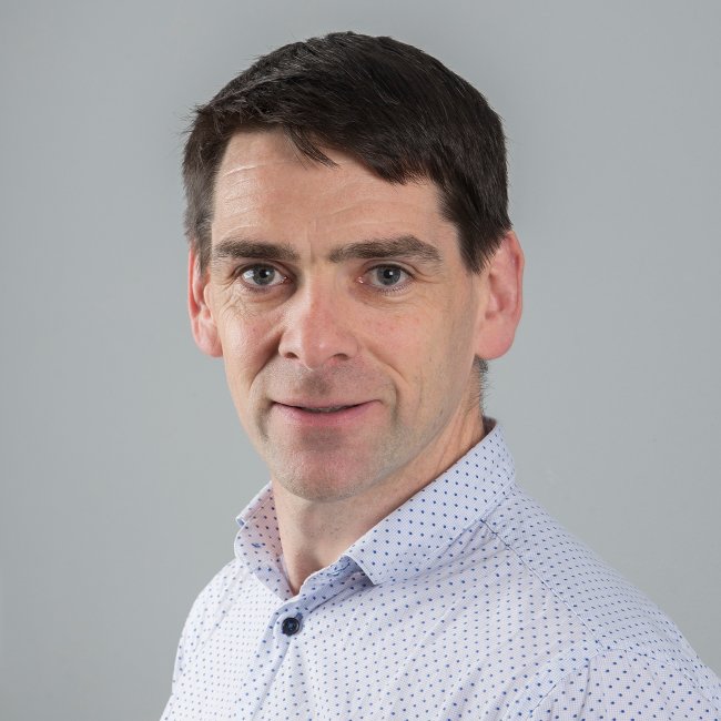 Dark-haired man in blue shirt.