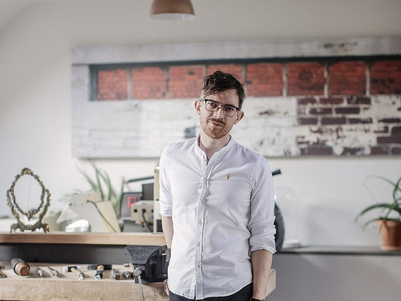 Man in glasses wearing white shirt.