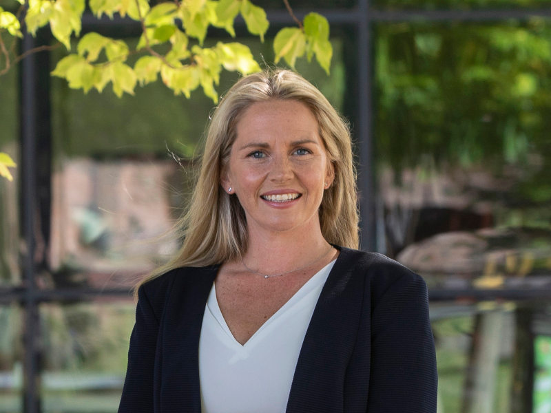 Blonde-haired woman in business suit.