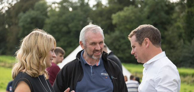 People talking at an event.