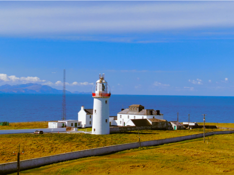 A white lighthouse on edge of Ireland's west coast at Loop Head.