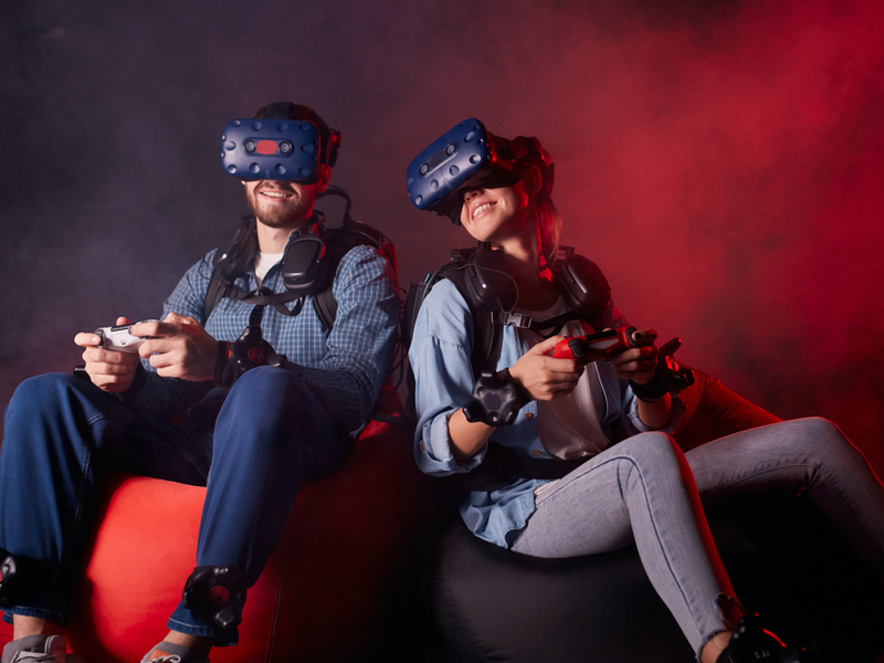 Man and woman wearing VR headgear.