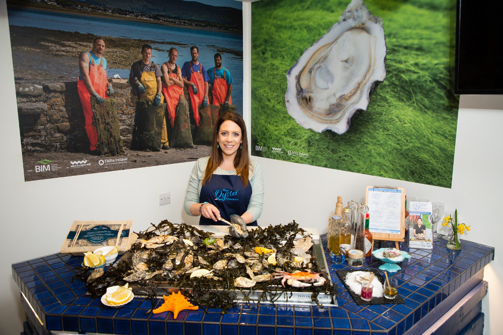 Woman shucking oysters.