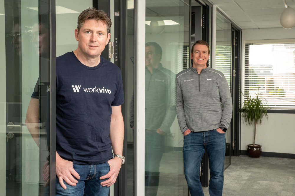 Two casually dressed men standing in an office.