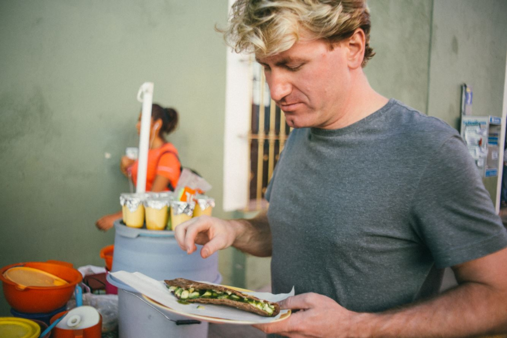 Fair-haired man cooking tortilla.